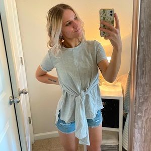 Grey shirt, longer in back.